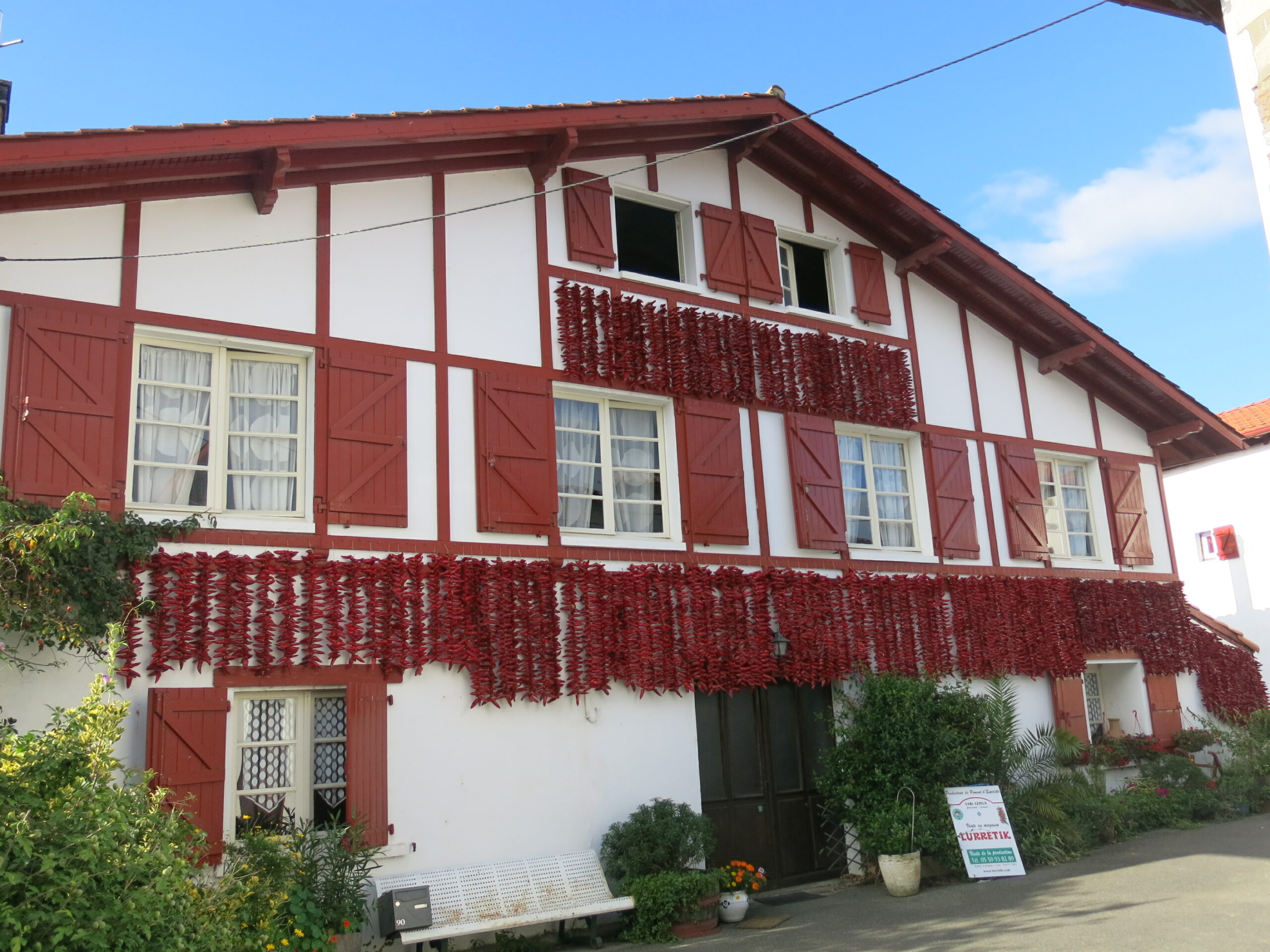 Traditional red-and-white house with drying peppers in Espelette